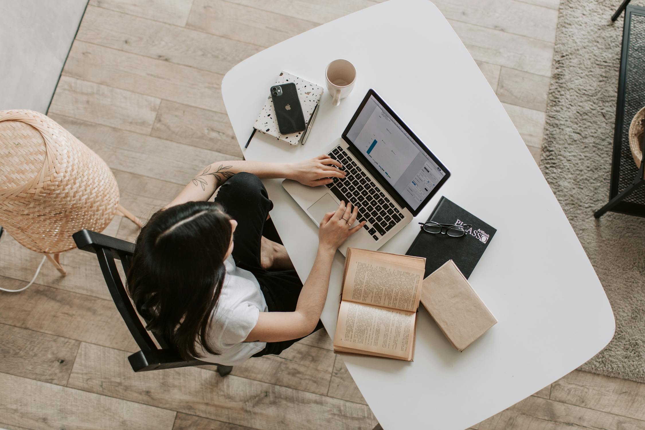 Professional virtual assistant workspace with laptop, notebook, and modern office setup